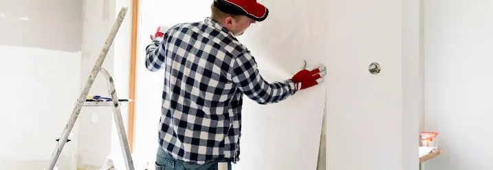 Person bringt Tapete an